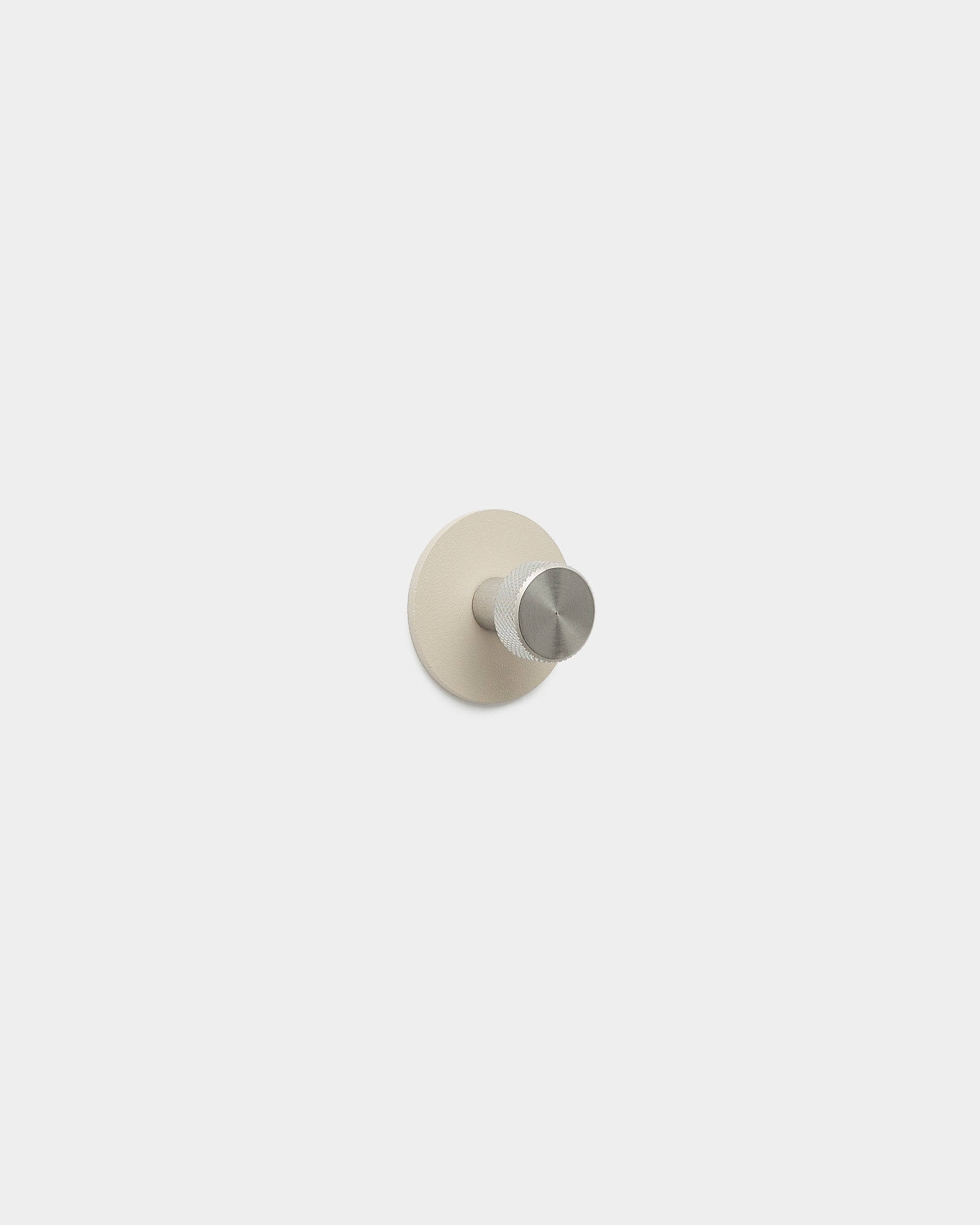 WoodUpp Norr Coat Hook in beige and stainless steel with a minimalist peg and round base, made from powder-coated steel, part of WoodUpp accessories.