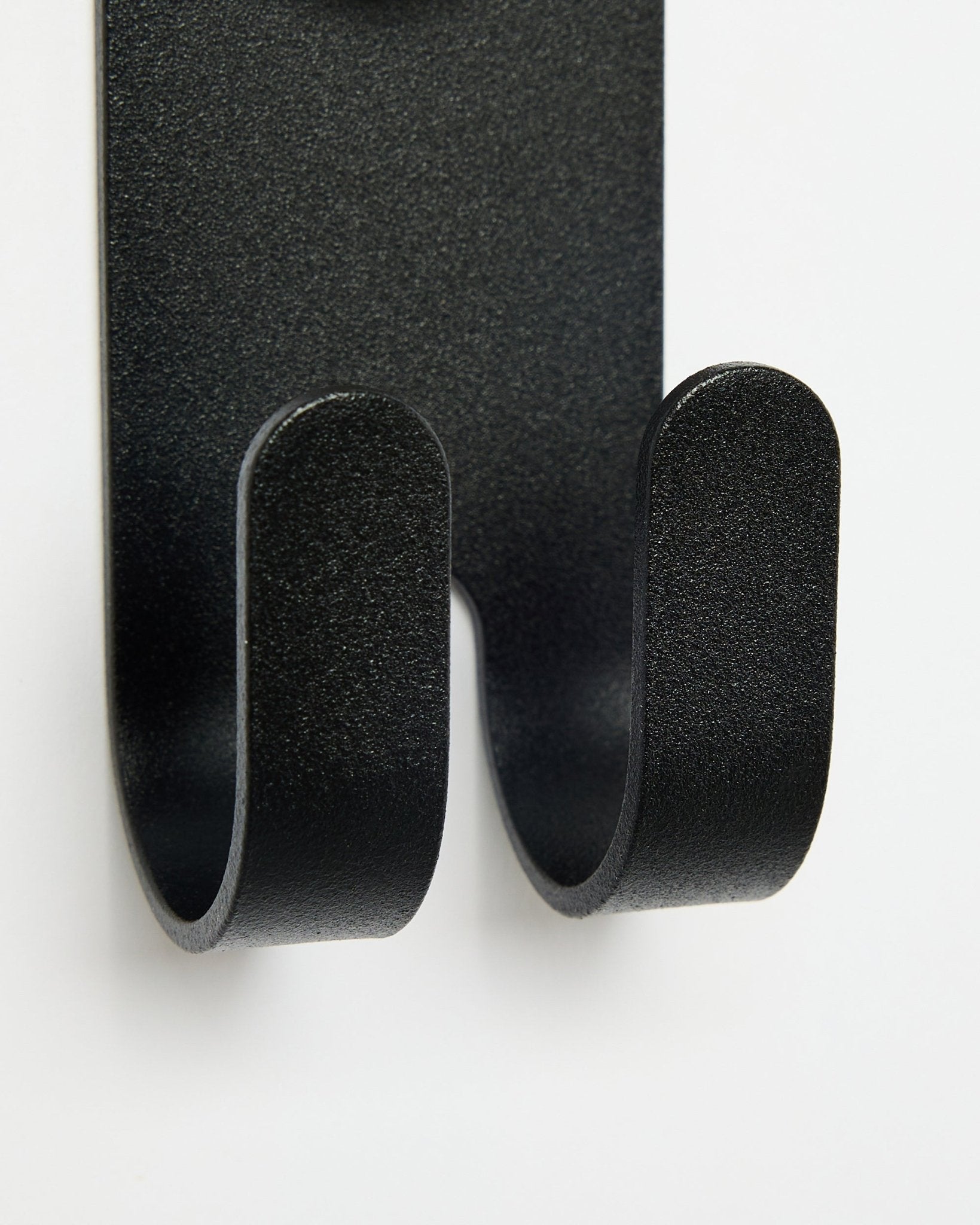 Close-up of the Norr Double Hanger in black by WoodUpp, showing double hooks designed for Akupanel accessories against a white background.